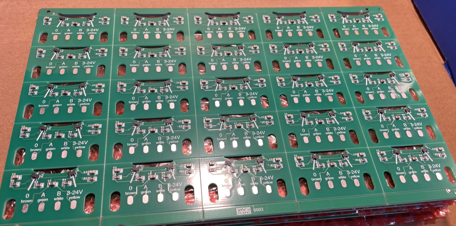 Panel of position-sensor PCBs with Hall sensors and wire pads labelled brown, green, white and yellow
